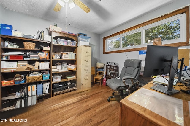 office with a textured ceiling, ceiling fan, and wood finished floors