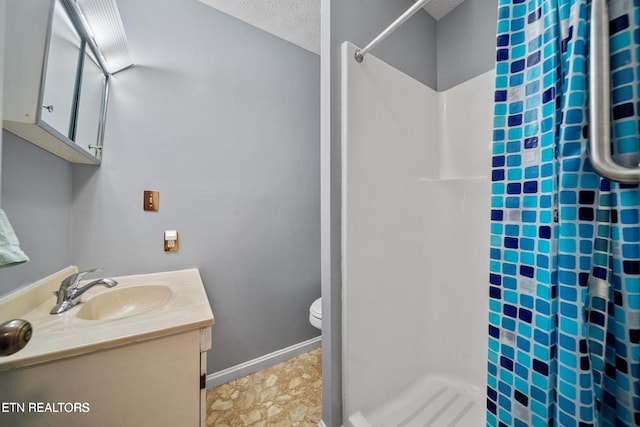bathroom featuring vanity, a stall shower, and toilet