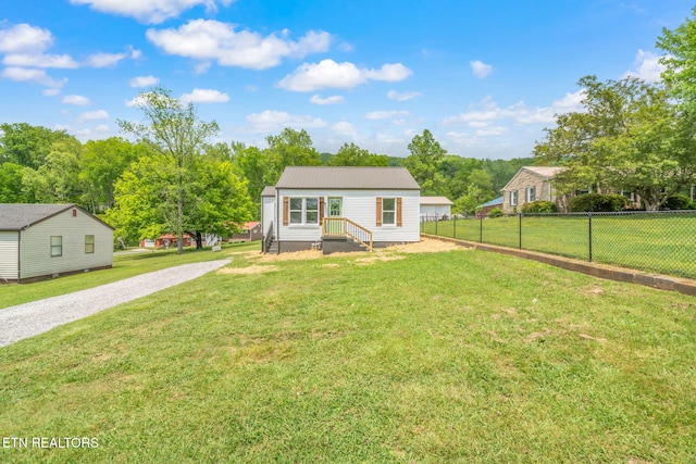 309 Evergreen St, Harriman, TN 37748 - bungalow featuring fence, a front lawn, and gravel driveway
