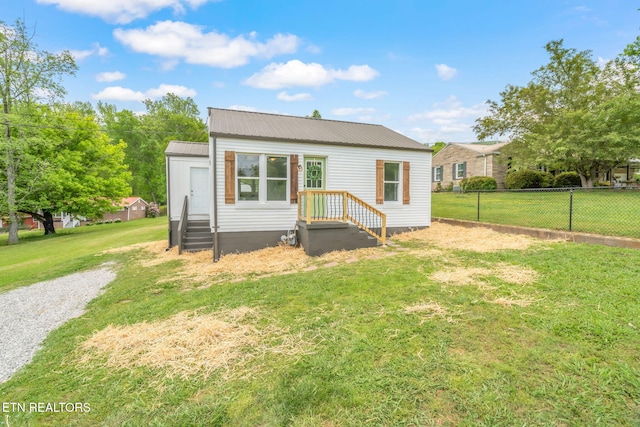 309 Evergreen St, Harriman, TN 37748 - back of house with fence, a yard, and metal roof