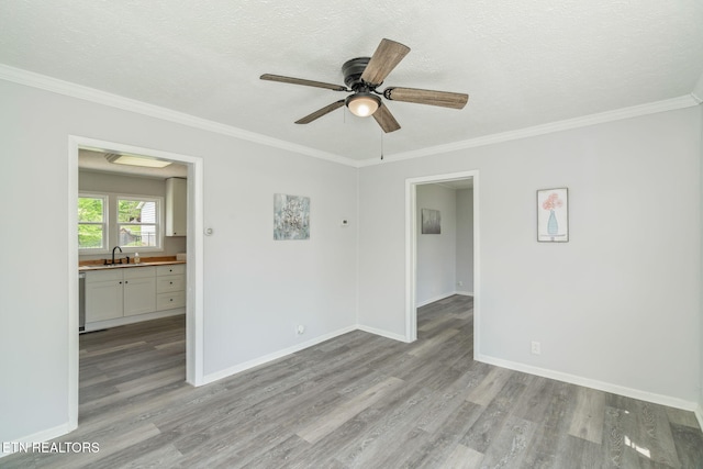 309 Evergreen St, Harriman, TN 37748 - empty room with crown molding, a ceiling fan, light wood-style floors, baseboards, and a sink