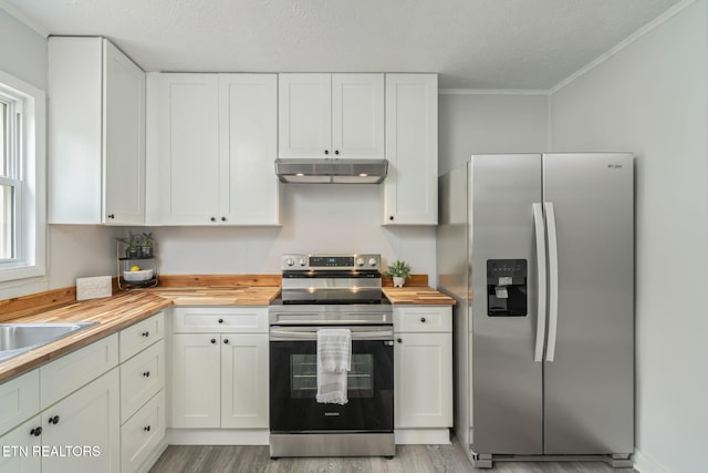 309 Evergreen St, Harriman, TN 37748 - kitchen with appliances with stainless steel finishes, light wood finished floors, butcher block counters, under cabinet range hood, and white cabinetry
