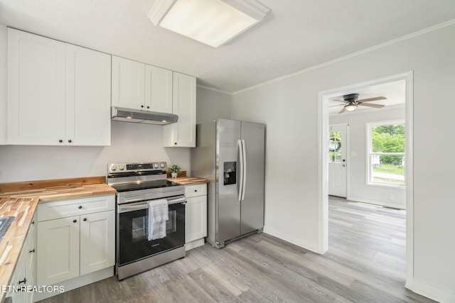 309 Evergreen St, Harriman, TN 37748 - kitchen featuring crown molding, butcher block countertops, under cabinet range hood, light wood finished floors, and stainless steel appliances
