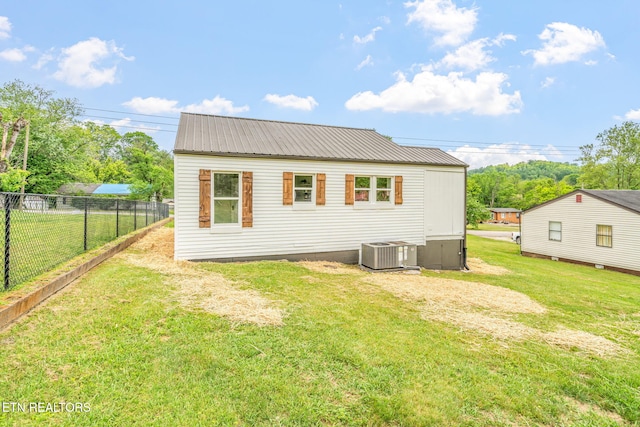 309 Evergreen St, Harriman, TN 37748 - exterior space with fence, a lawn, cooling unit, and metal roof