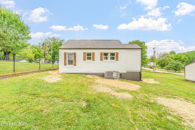 309 Evergreen St, Harriman, TN 37748 - back of property with a yard, fence, central AC unit, and metal roof