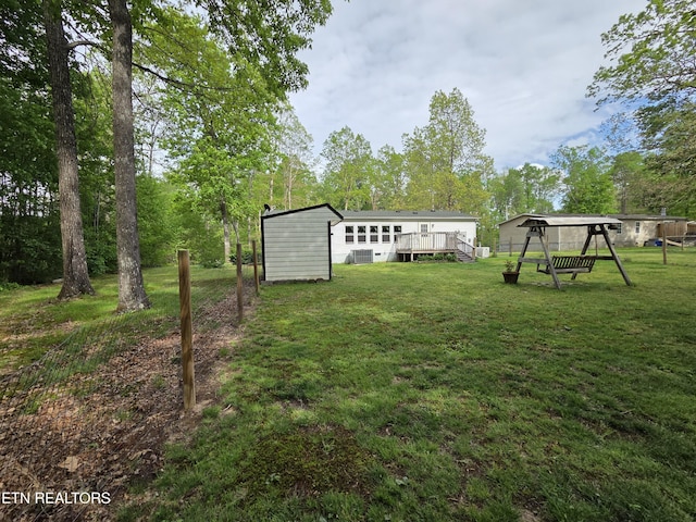 view of yard featuring a wooden deck and central AC unit