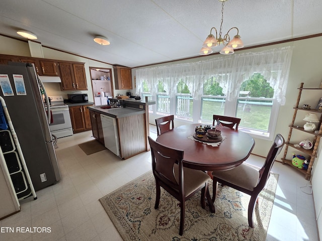 dining area with an inviting chandelier, light floors, lofted ceiling, and a healthy amount of sunlight