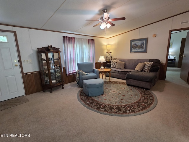 living area with a ceiling fan, vaulted ceiling, wainscoting, and carpet