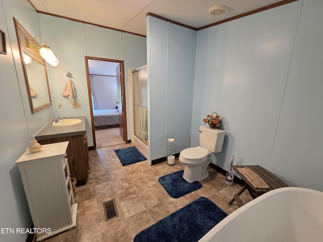 bathroom featuring visible vents, a freestanding tub, vanity, toilet, and connected bathroom