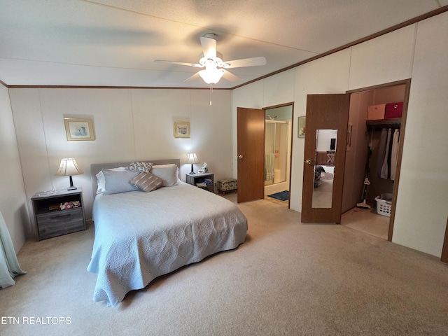 bedroom with a ceiling fan, lofted ceiling, ensuite bath, and light colored carpet