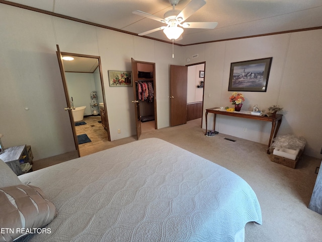 bedroom featuring carpet floors, visible vents, connected bathroom, a spacious closet, and a ceiling fan