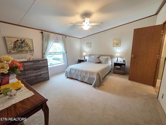bedroom featuring carpet floors, a ceiling fan, crown molding, and vaulted ceiling