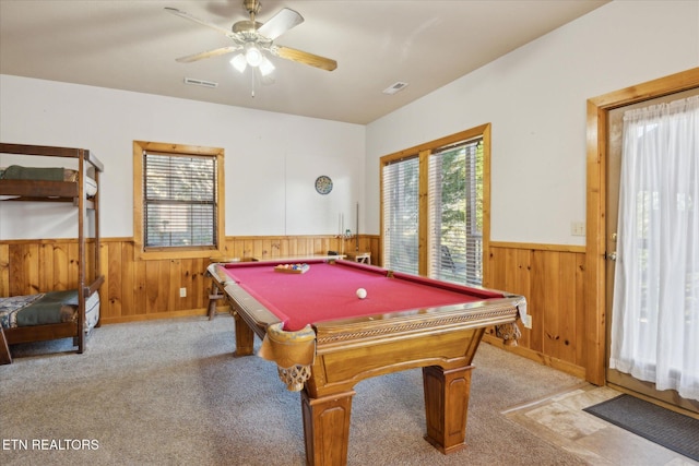 rec room with wooden walls, visible vents, and wainscoting