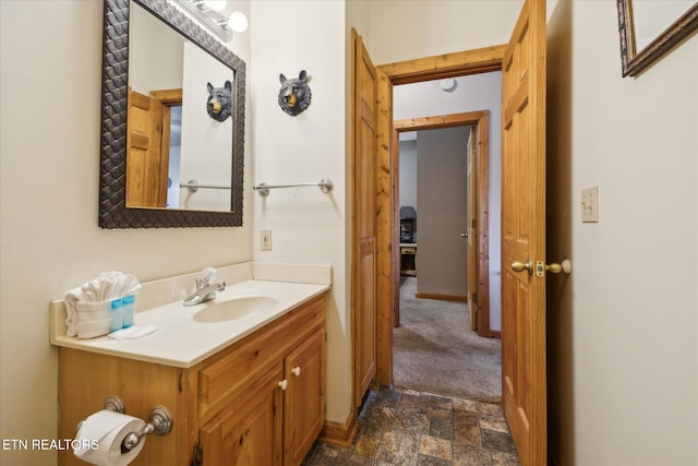 bathroom with vanity and stone finish flooring