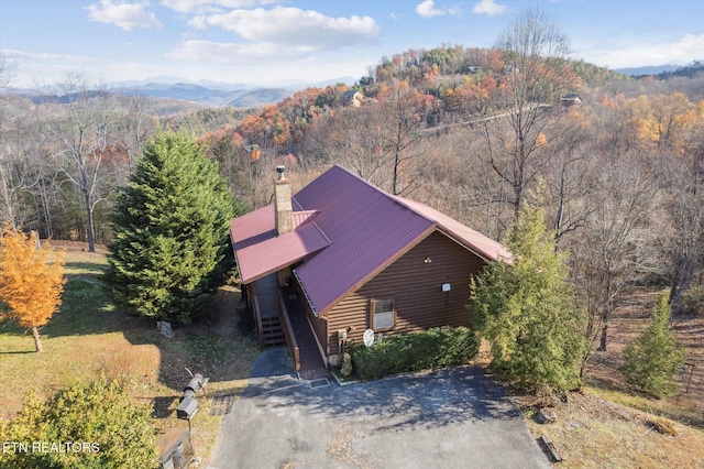 drone / aerial view featuring a view of trees and a mountain view