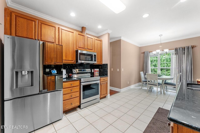 4322 Wellesley Dr, Ooltewah, TN 37363 - kitchen with a chandelier, stainless steel appliances, baseboards, backsplash, and ornamental molding