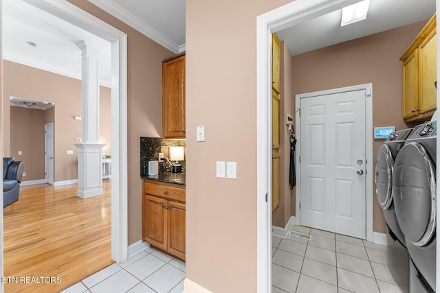 4322 Wellesley Dr, Ooltewah, TN 37363 - clothes washing area featuring washing machine and dryer, cabinet space, baseboards, ornate columns, and light tile patterned flooring