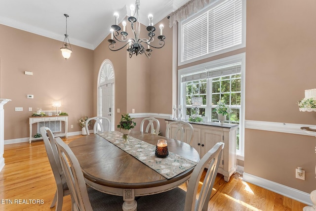 4322 Wellesley Dr, Ooltewah, TN 37363 - dining space with high vaulted ceiling, baseboards, light wood finished floors, a chandelier, and ornamental molding