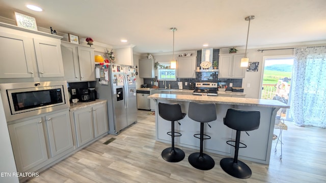 210 Schertz Ln, Rutledge, TN 37861 - kitchen with crown molding, a kitchen breakfast bar, wall chimney exhaust hood, stainless steel appliances, and backsplash