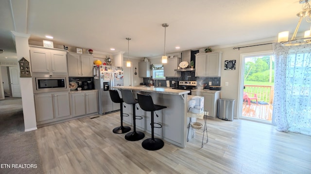 210 Schertz Ln, Rutledge, TN 37861 - kitchen with wall chimney range hood, backsplash, appliances with stainless steel finishes, and plenty of natural light