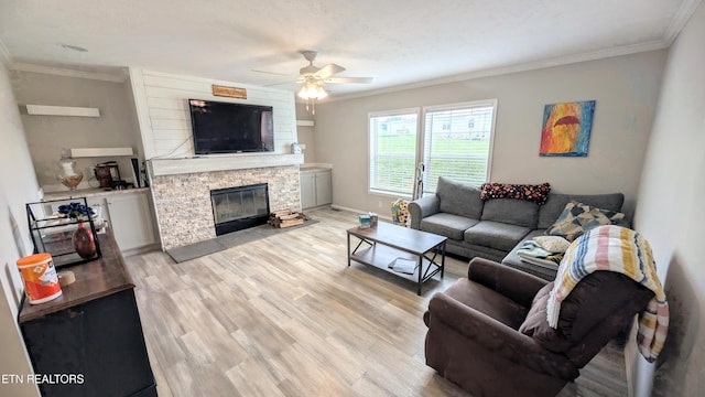 210 Schertz Ln, Rutledge, TN 37861 - living area featuring a stone fireplace, a ceiling fan, light wood finished floors, and crown molding