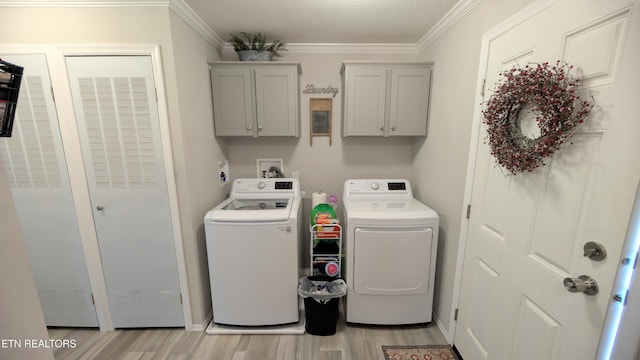 210 Schertz Ln, Rutledge, TN 37861 - clothes washing area with ornamental molding, light wood-style flooring, cabinet space, and washer and dryer