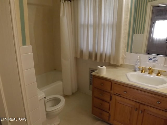 full bath with toilet, vanity, shower / bathtub combination with curtain, and wallpapered walls