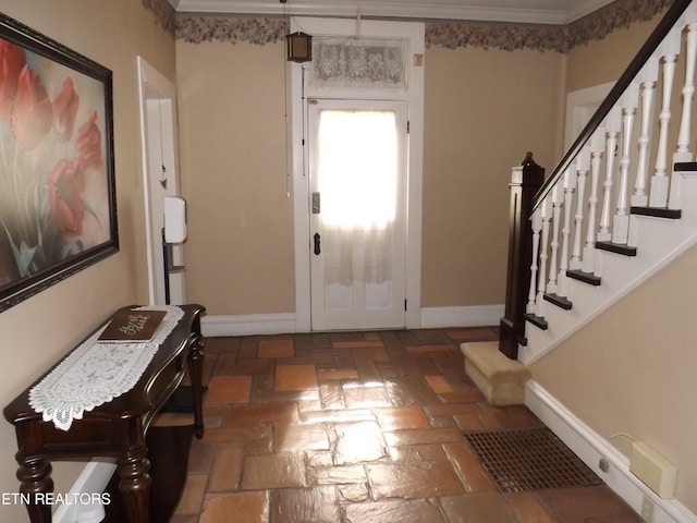 entryway featuring stairway, ornamental molding, and baseboards