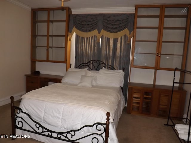 carpeted bedroom featuring crown molding