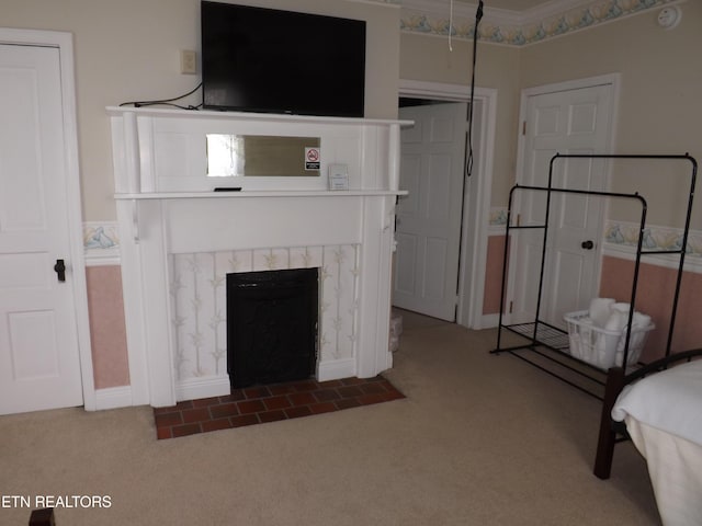 unfurnished living room with carpet floors, a fireplace, and baseboards