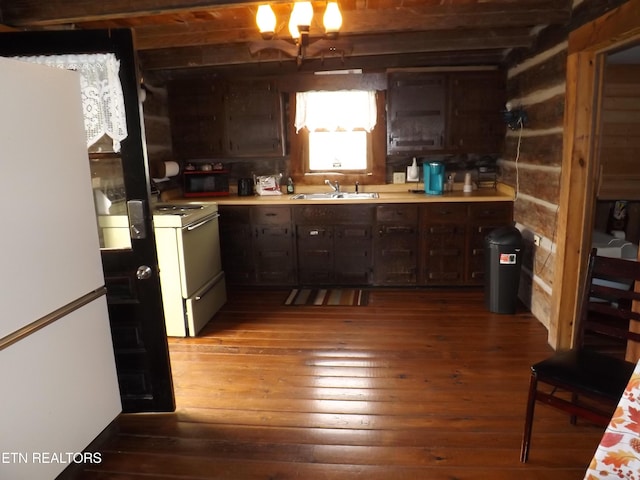 kitchen featuring white appliances, hardwood / wood-style floors, a sink, light countertops, and dark brown cabinetry
