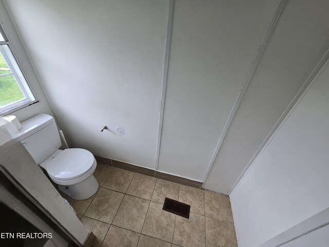 bathroom with visible vents, tile patterned floors, and toilet