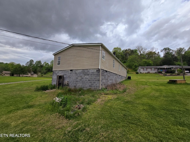 view of property exterior featuring a lawn and crawl space