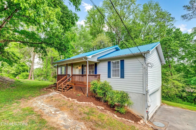 330 Ridgeview Dr, Oliver Springs, TN 37840 - ranch-style home featuring a garage, covered porch, driveway, and metal roof