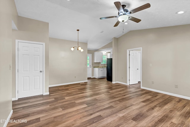 330 Ridgeview Dr, Oliver Springs, TN 37840 - unfurnished living room with baseboards, ceiling fan with notable chandelier, and wood finished floors