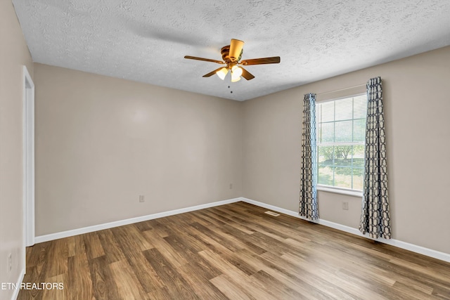 330 Ridgeview Dr, Oliver Springs, TN 37840 - unfurnished room with baseboards, a textured ceiling, ceiling fan, and wood finished floors