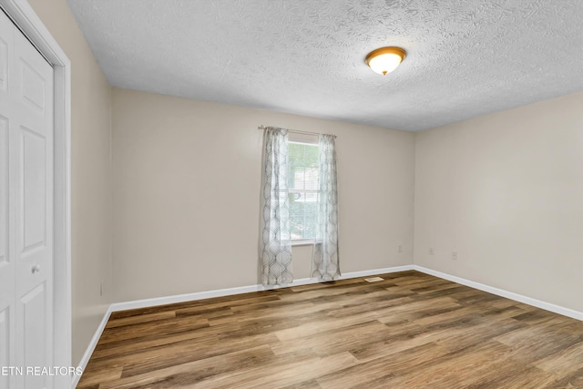 330 Ridgeview Dr, Oliver Springs, TN 37840 - spare room featuring baseboards, a textured ceiling, and wood finished floors