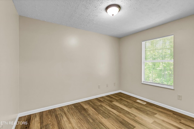 330 Ridgeview Dr, Oliver Springs, TN 37840 - empty room with baseboards, a textured ceiling, wood finished floors, and visible vents