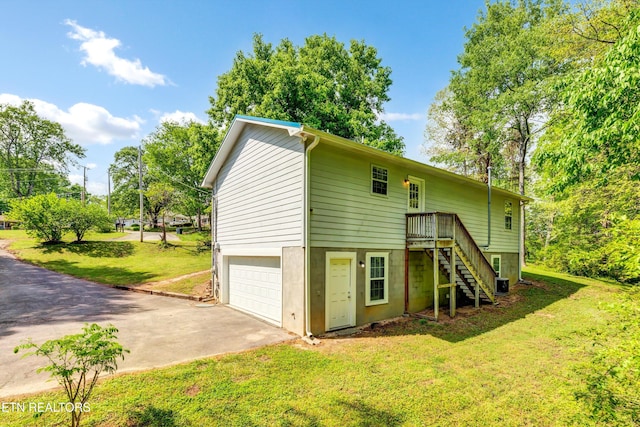 330 Ridgeview Dr, Oliver Springs, TN 37840 - rear view of property featuring stairs, a garage, cooling unit, concrete driveway, and a lawn