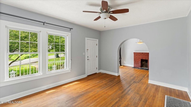 953 Maynard Ave, Knoxville, TN 37917 - unfurnished room with a fireplace, wood finished floors, baseboards, ceiling fan, and a textured ceiling