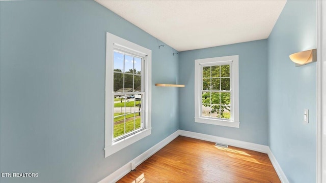 953 Maynard Ave, Knoxville, TN 37917 - unfurnished room featuring healthy amount of natural light, baseboards, and wood finished floors