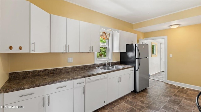 953 Maynard Ave, Knoxville, TN 37917 - kitchen with dishwasher, a sink, freestanding refrigerator, dark countertops, and baseboards