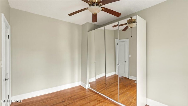 953 Maynard Ave, Knoxville, TN 37917 - unfurnished bedroom with wood finished floors, baseboards, a closet, and a ceiling fan