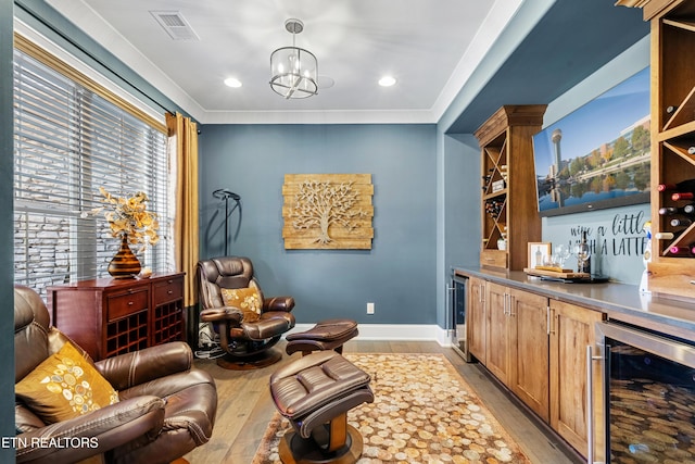 214 Watercrest Dr, Vonore, TN 37885 - sitting room featuring visible vents, baseboards, a bar, beverage cooler, and light wood-style floors