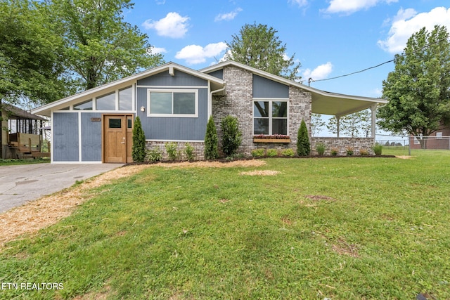 mid-century home featuring fence, a front yard, and brick siding