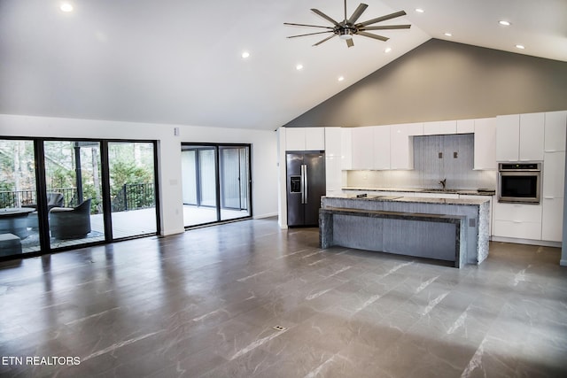 194 Forest View Dr, Crossville, TN 38558 - kitchen with a kitchen island, a sink, high vaulted ceiling, white cabinets, and stainless steel appliances