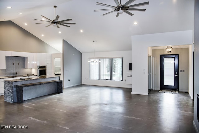 194 Forest View Dr, Crossville, TN 38558 - unfurnished living room with recessed lighting, high vaulted ceiling, baseboards, and ceiling fan with notable chandelier