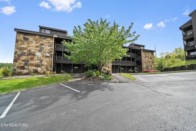 view of building exterior featuring uncovered parking