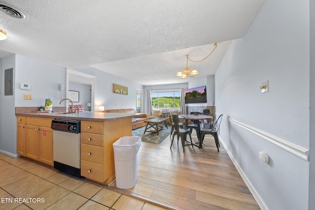kitchen with dishwasher, open floor plan, a textured ceiling, a chandelier, and a sink