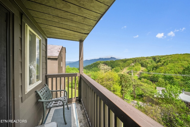balcony with a mountain view and a wooded view